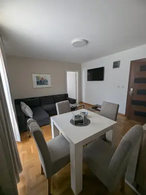 a living room with a white table and chairs at Vila Simfonija in Vrnjačka Banja