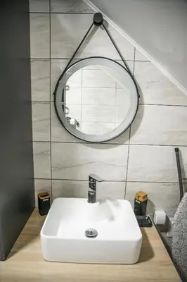 a bathroom with a white sink and a mirror at NOMAD Apartments in Niš
