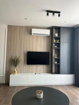 a living room with a television on a wall at NOMAD Apartments in Niš