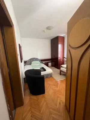 a bedroom with a bed and a chair in a room at Vila Grinka M in Zaječar