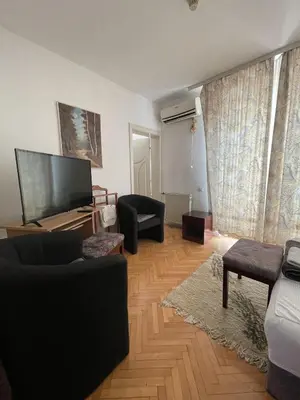 a living room with a flat screen tv and a couch at Vila Grinka M in Zaječar