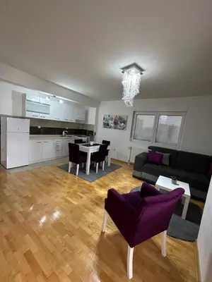 a living room with a couch and a table at Nis Apartment in Niš