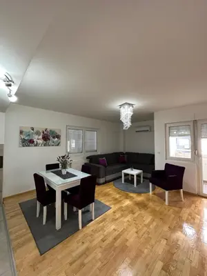 a living room with a couch and a table at Nis Apartment in Niš