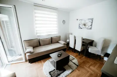 a living room with a couch and a table at Apartman Ksenija in Vrnjačka Banja