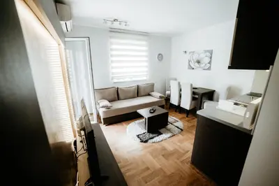a living room with a couch and a table at Apartman Ksenija in Vrnjačka Banja