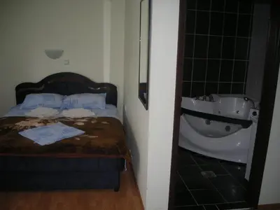 a bedroom with a bed and a bath tub at UTR Jagnjilo 1986 in Raška