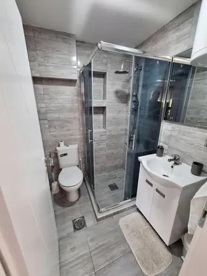 a bathroom with a shower and a toilet and a sink at Soko apartments in Jagodina