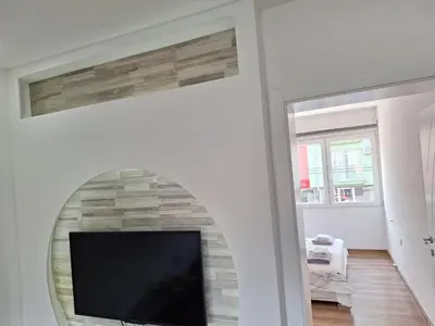 a living room with a tv and a fireplace at Soko apartments in Jagodina