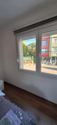 an empty room with two windows in a building at Soko apartments in Jagodina