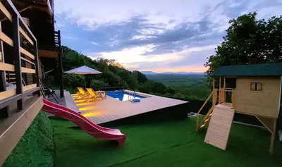 a backyard with a slide and a swimming pool at Vikendica Ristic in Knjazevac.