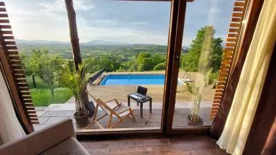 a view of a pool from a room with a window at Vikendica Ristic in Knjazevac.