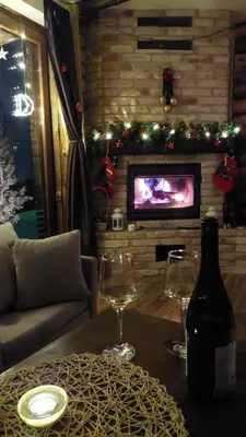 a living room with a bottle of wine and wine glasses at Vikendica Ristic in Knjazevac.