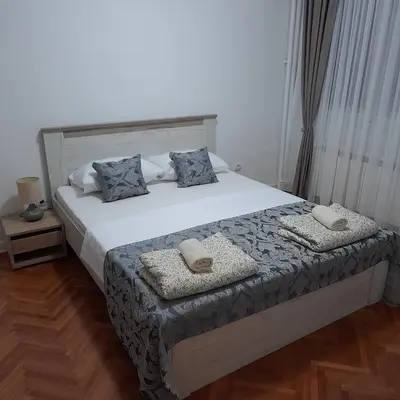 a bedroom with a bed with two pillows on it at Apartman Mika **Centar ** in Kruševac