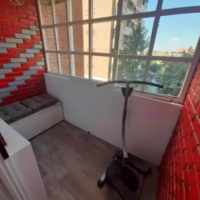 a room with a scooter in front of a window at Apartman Mika **Centar ** in Kruševac