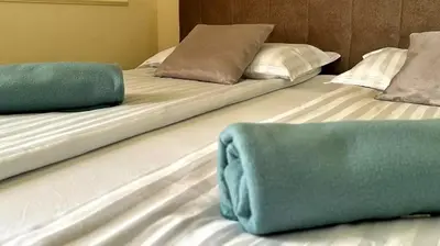 two beds sitting next to each other in a room at Happy moment Niš in Niš