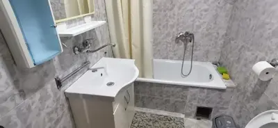 a bathroom with a sink and a shower and a tub at Happy moment Niš in Niš