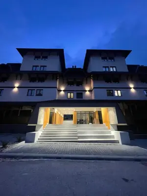 a large building with stairs in front of it at Bela Reka C320 Kopaonik Brzece in Brzeće
