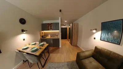a living room with a table and a couch at Bela Reka C320 Kopaonik Brzece in Brzeće