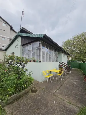a yellow table and chairs in front of a house at VILA MILA SOKOBANJA in Soko Banja
