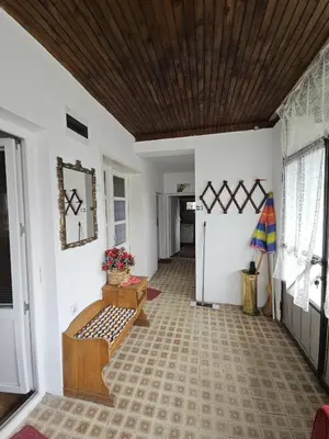 a hallway with white walls and a wooden ceiling at VILA MILA SOKOBANJA in Soko Banja