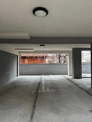 an empty parking garage with a light on the ceiling at Niš East gate APT with balcony and free private Parking in Donja Vrežina