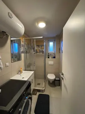 a bathroom with a shower and a sink and a toilet at Niš East gate APT with balcony and free private Parking in Donja Vrežina
