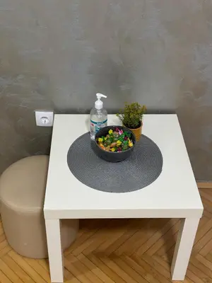 a white table with a bowl of candy on it at Loli apartman in Kraljevo