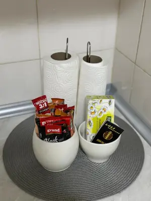a table with two bowls of snacks and toilet paper at Loli apartman in Kraljevo