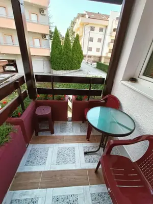 a balcony with a table and chairs in a building at Apartman Putnik in Vrnjačka Banja