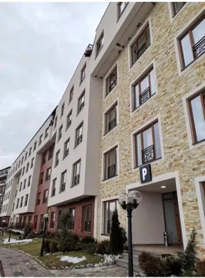 a large building with a parking sign in front of it at Milmari M3A in Kopaonik