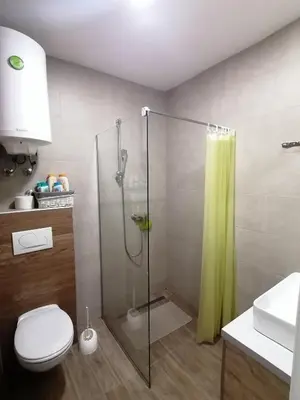 a bathroom with a shower and a toilet and a sink at Milmari M3A in Kopaonik