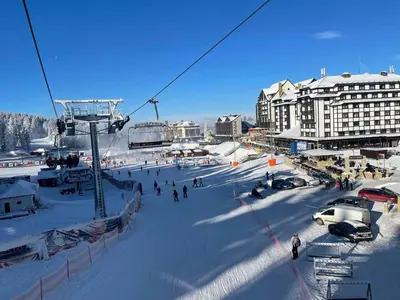 a group of people on a ski lift in the snow at Milmari M3A in Kopaonik
