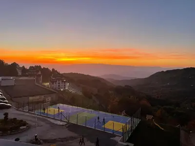 a sunset in the mountains with a swimming pool at Milmari M3A in Kopaonik