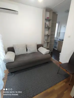 a living room with a couch and a chair at Marta i Marija in Vrnjačka Banja