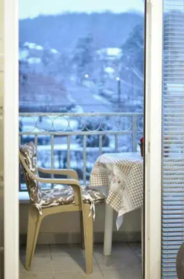 a chair and a table on a balcony at Marta i Marija in Vrnjačka Banja