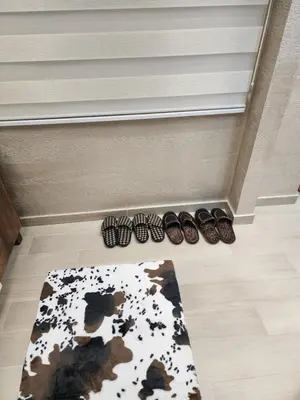 a group of shoes and a rug on a floor at Ebra 76 Kraljevi Cardaci Kopaonik in Kopaonik