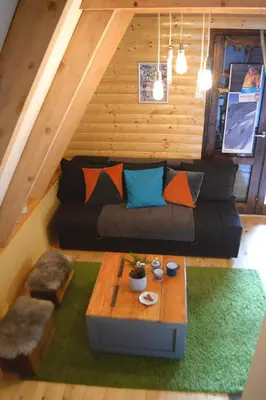 a living room with a couch and a table at Cabin & Apartment Kopaonik in Kopaonik