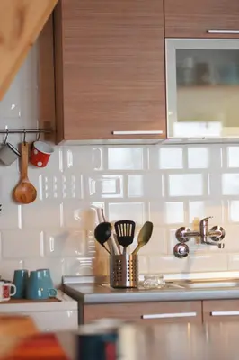 a kitchen with white tiles on the wall at Cabin & Apartment Kopaonik in Kopaonik