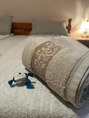 a toy on a bed with a blanket on it at Apartman 23 in Kraljevo