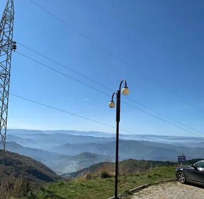 a car parked next to a street light on a mountain at Milmari I2 Studio LUX Apartman in Kopaonik