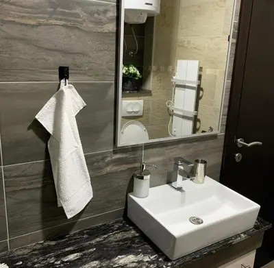 a bathroom with a white sink and a mirror at Milmari I2 Studio LUX Apartman in Kopaonik