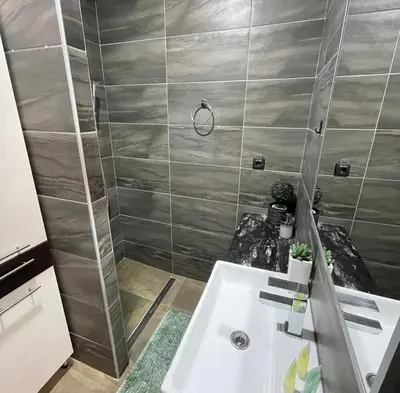 a bathroom with a sink and a shower at Milmari I2 Studio LUX Apartman in Kopaonik