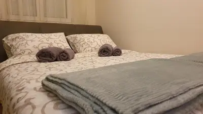 a bed with two stuffed animals on top of it at Apartman Iris in Niš