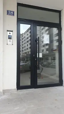 an entrance to a building with a revolving door at Apartman Iris in Niš