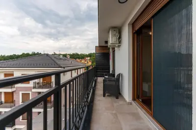 a balcony with a view of a building at MED Apartmani in Vrnjačka Banja