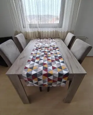 a wooden table with a checkered table cloth on it at Apartman Bogdan in Soko Banja