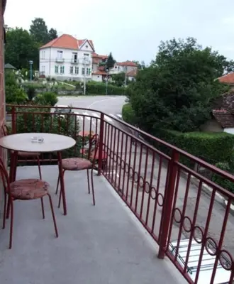 a table and chairs sitting on a balcony at Apartman Bogdan in Soko Banja
