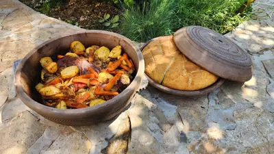 a pot of food next to a bowl of bread at Gore Dole in Donji Matejevac