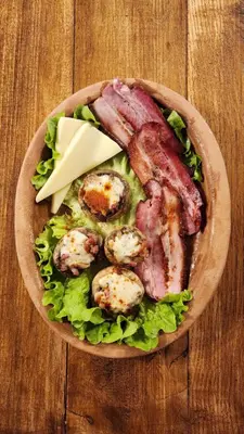 a plate of food with meat and vegetables on a table at Gore Dole in Donji Matejevac
