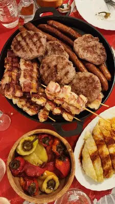 a table with two plates of food on a table at Gore Dole in Donji Matejevac